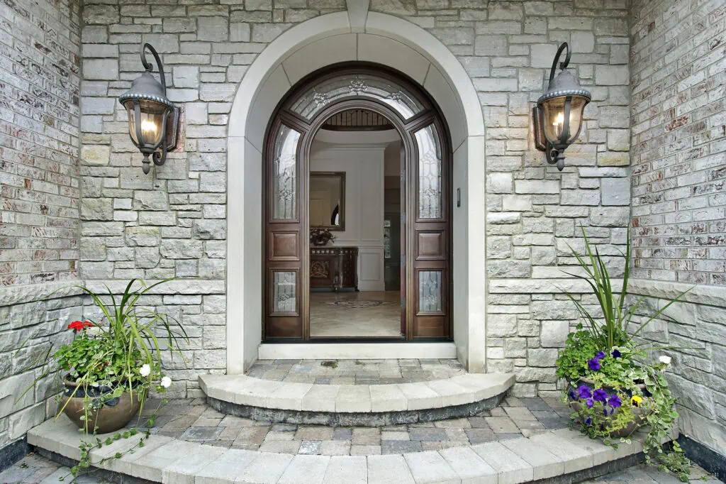 Arched stone entry of luxury suburban home